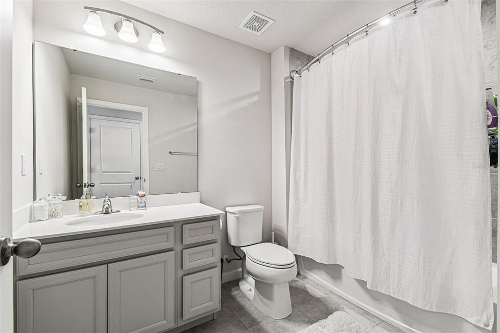 19043 Pebble Wood Ln Spring Hill Spring Hill, FL 34610 - Photo 26 of 35 a bathroom with a sink a toilet and a mirror