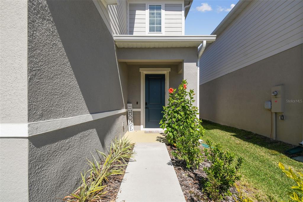 19043 Pebble Wood Ln Spring Hill Spring Hill, FL 34610 - Photo 3 of 35 a entryway with flower pots