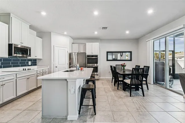 a view of kitchen with sink dining table and chairs