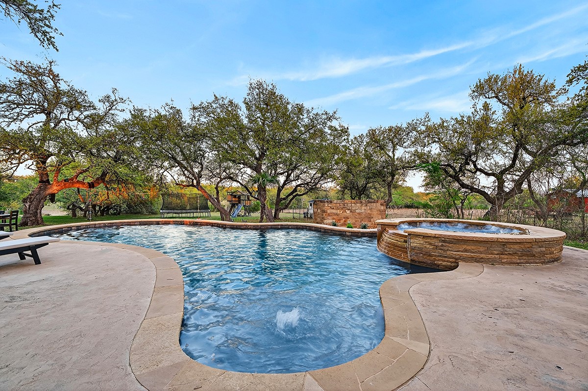 301 Medlin Creek Loop Dripping Springs, TX 78620 - Photo 32 of 40 a view of swimming pool having outdoor seating