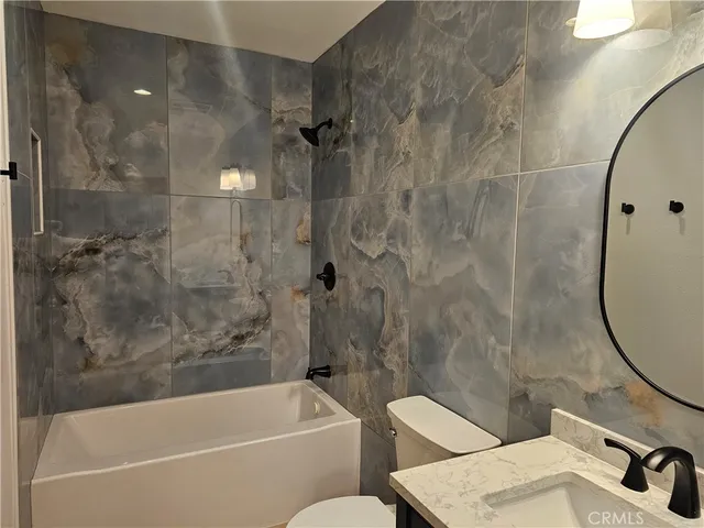 a bathroom with a sink a toilet and a bathtub