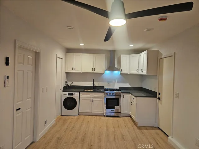 a kitchen with a stove a sink and a refrigerator