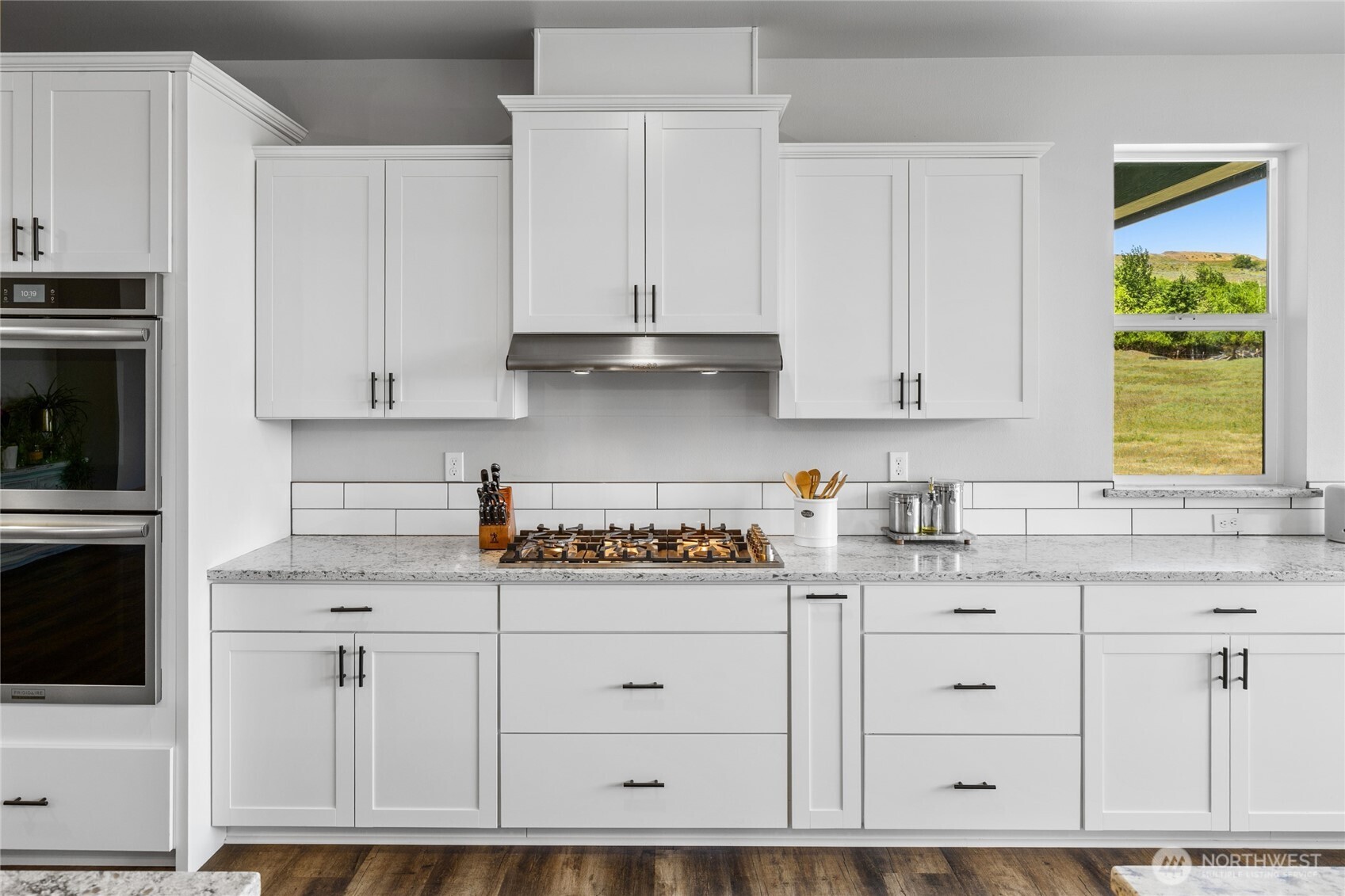 1590 Hunter Road Ellensburg, WA 98926 - Photo 15 of 40 a kitchen with granite countertop white cabinets and white appliances
