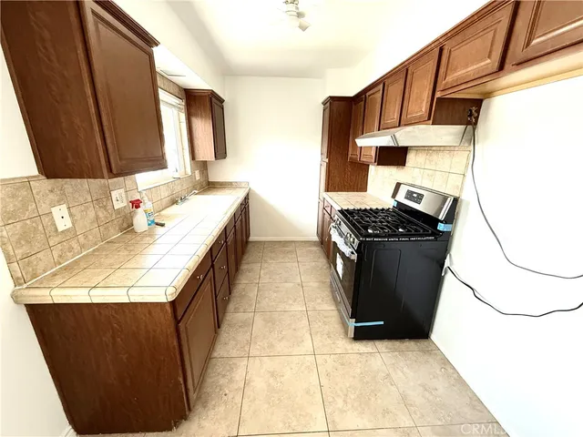 a kitchen with a sink a stove and refrigerator