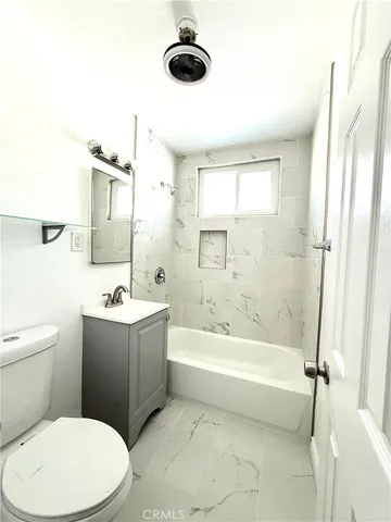 a bathroom with a toilet a sink and a bathtub