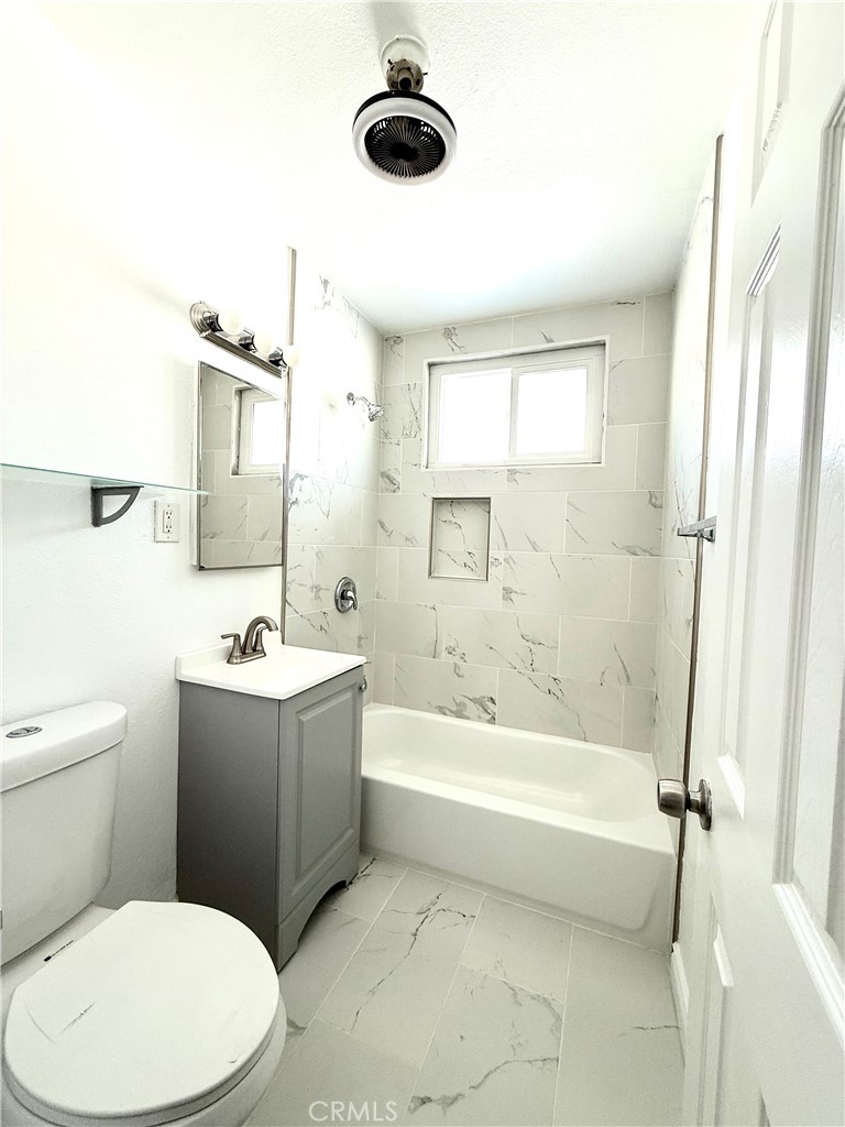 489 West Alpine Street, Unit F Upland, CA 91786 - Photo 8 of 12 a bathroom with a toilet a sink and a bathtub