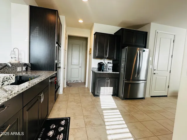 a kitchen with stainless steel appliances a refrigerator and a sink