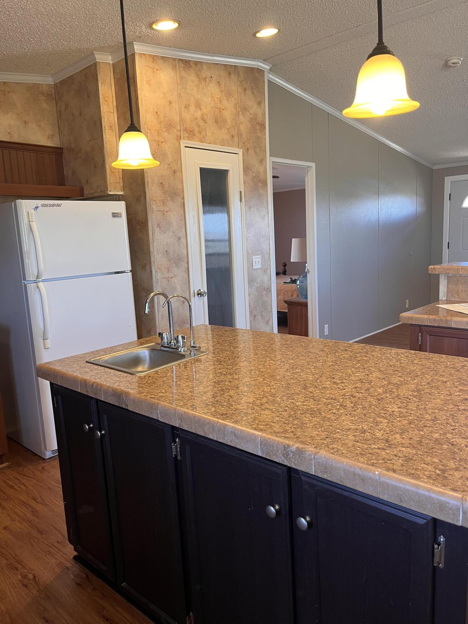 35 Rangeview Road Spur, TX 79370 - Photo 13 of 36 a bathroom with a granite countertop sink and a mirror