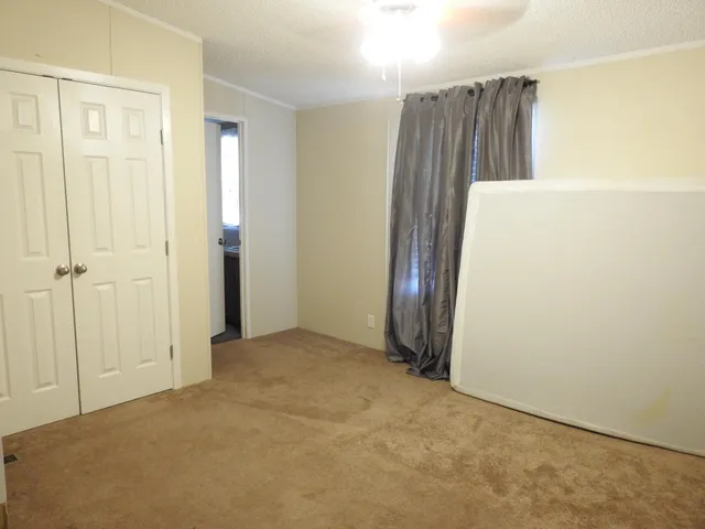 a blue bed sitting in a bedroom next to a window