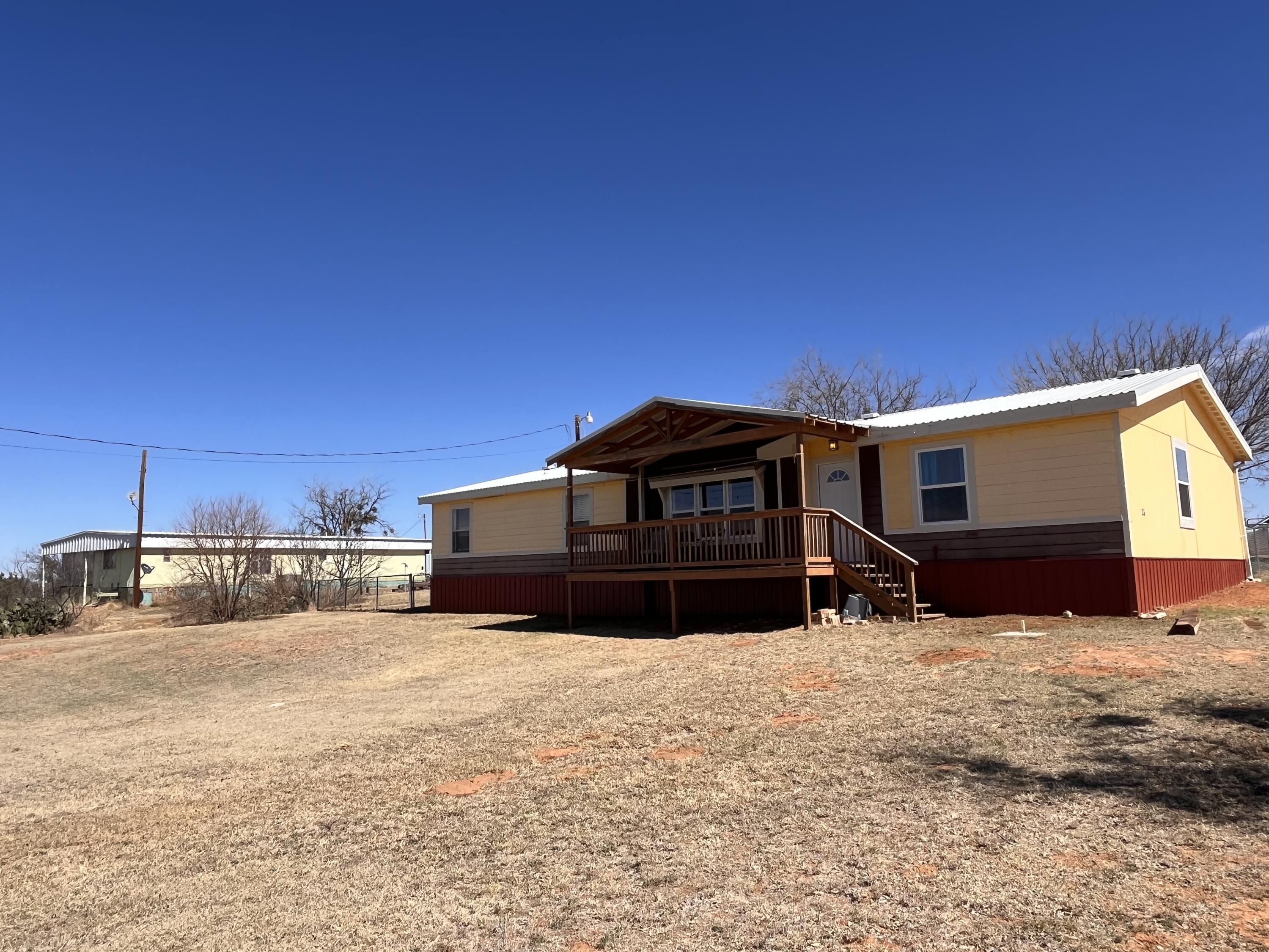 35 Rangeview Road Spur, TX 79370 - Photo 2 of 36 a front view of a house with a yard covered in snow