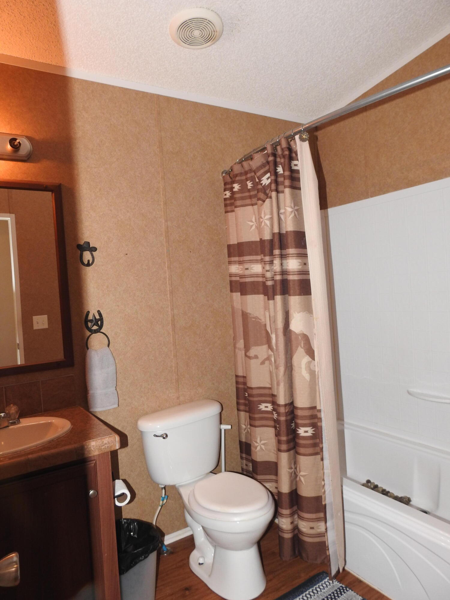 35 Rangeview Road Spur, TX 79370 - Photo 23 of 36 a bathroom with a toilet and a shower curtain