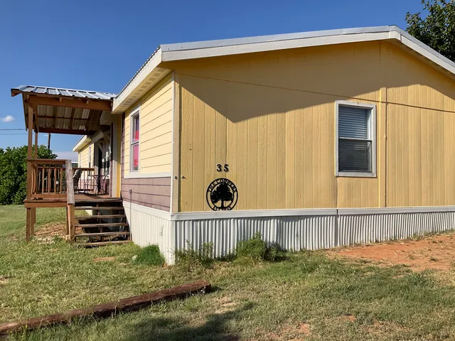 a view of a pathway with a wrought fence