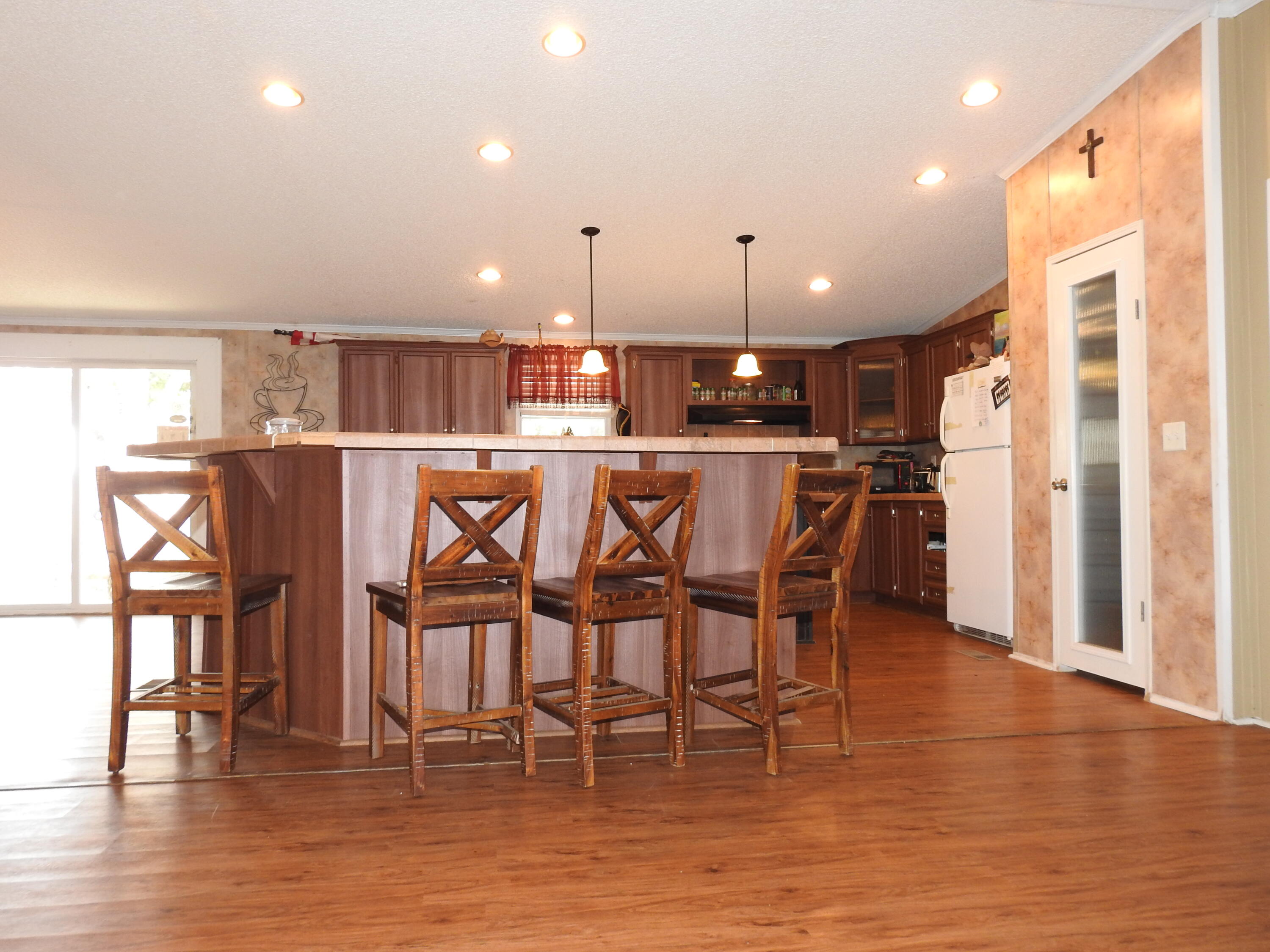 35 Rangeview Road Spur, TX 79370 - Photo 8 of 34 a view of a dining area with furniture and wooden floor