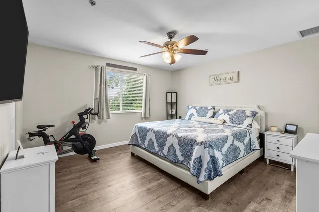 a bedroom with a bed and a large window