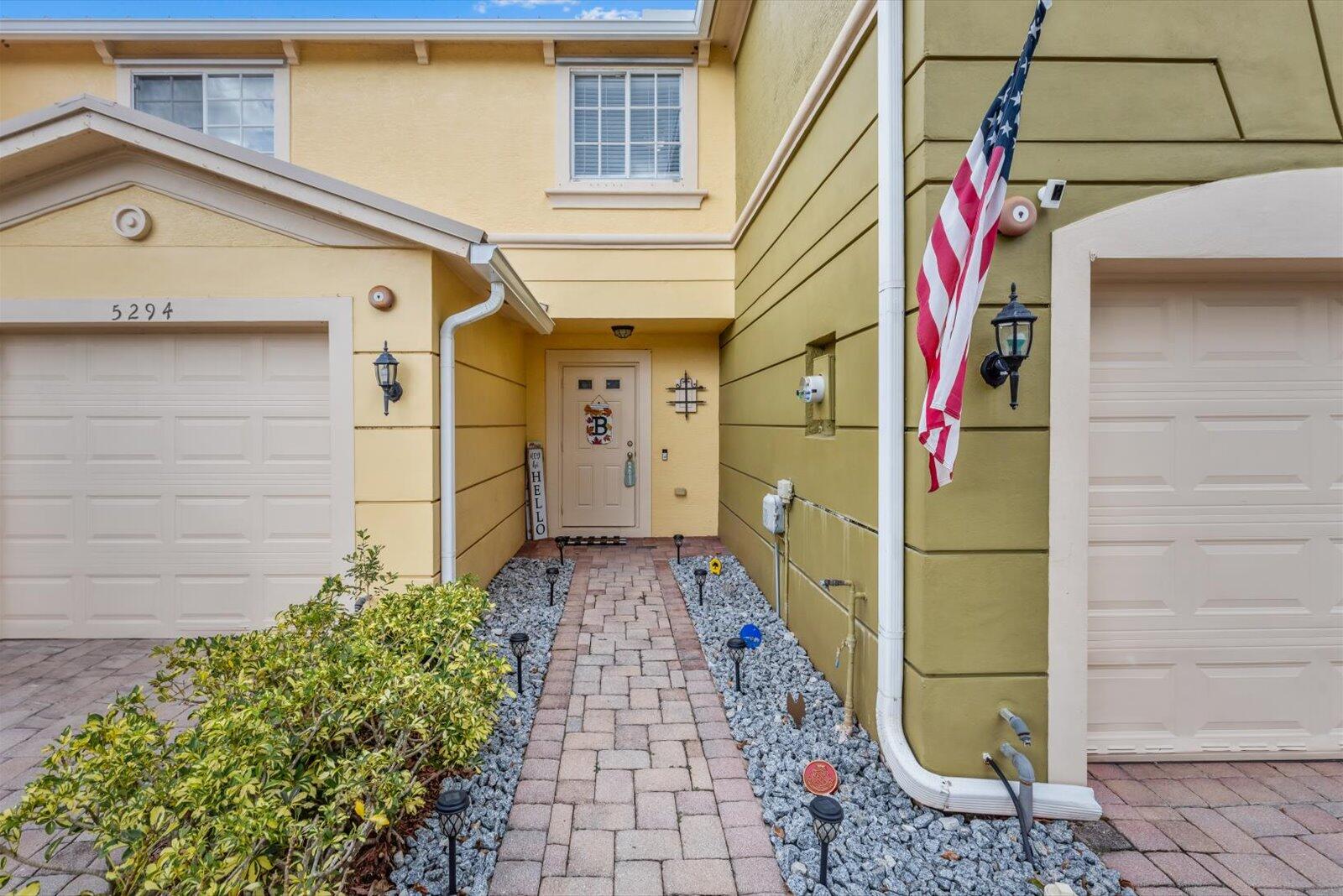 5290 Southeast Mitchell Lane Stuart, FL 34997 - Photo 2 of 44 a front view of a house with a yard