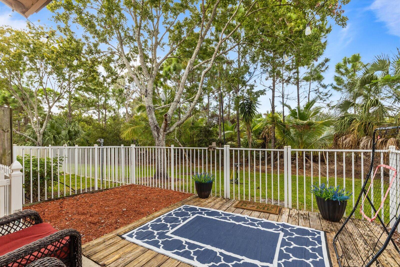 5290 Southeast Mitchell Lane Stuart, FL 34997 - Photo 28 of 44 a view of a roof deck with wooden fence and floor