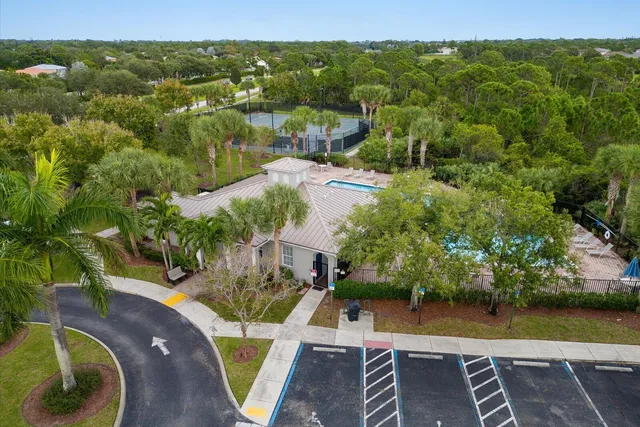 an aerial view of a house with a yard and lake view