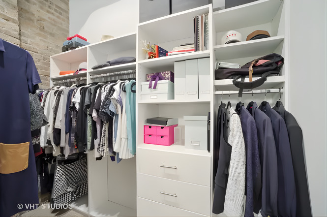 1040 West Adams Street, Unit 226 Chicago, IL 60607 - Photo 11 of 22 a view of walk in closet with clothes and shoes