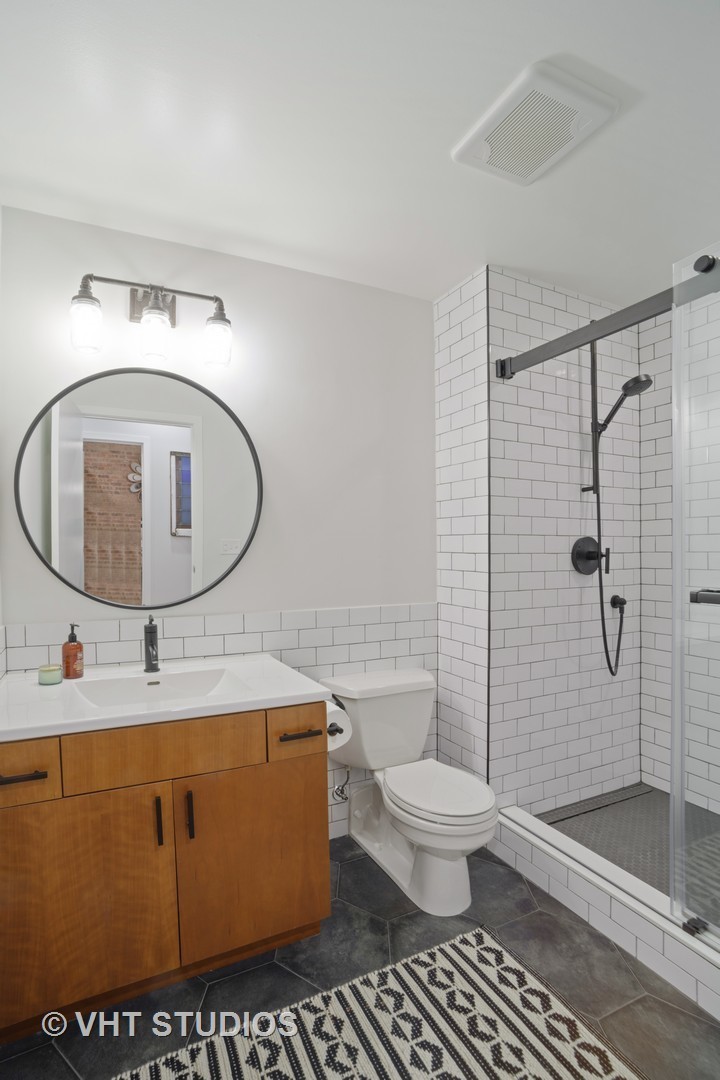 1040 West Adams Street, Unit 226 Chicago, IL 60607 - Photo 12 of 22 a bathroom with a sink mirror toilet and shower