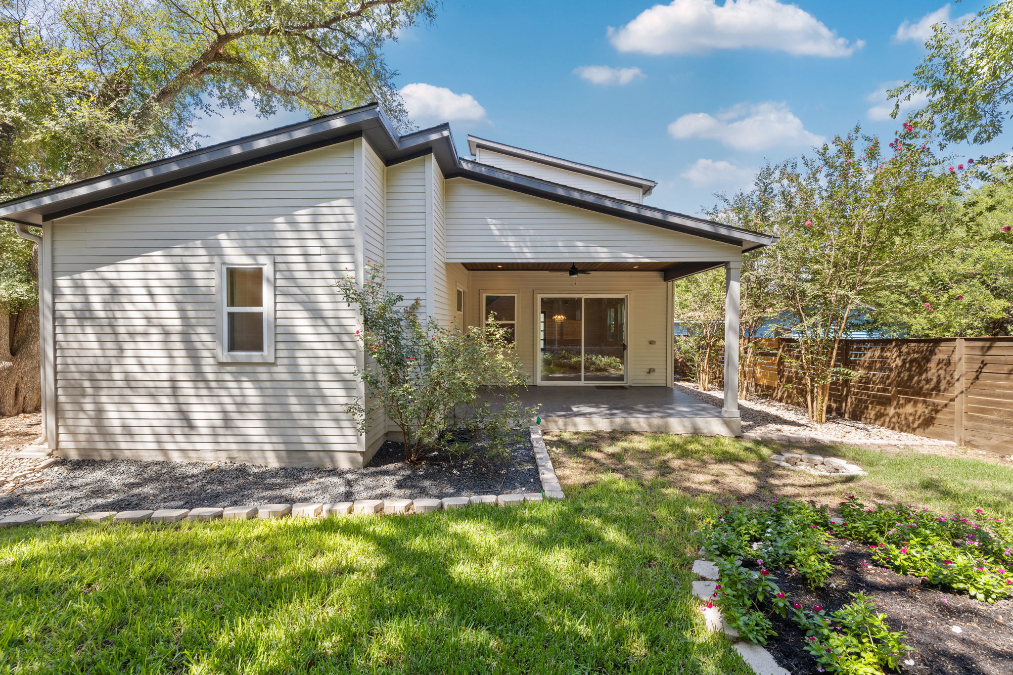 1719 Bunche Road Austin, TX 78721 - Photo 32 of 36 An inviting covered patio overlooks the manicured green lawn and landscaped backyard.
