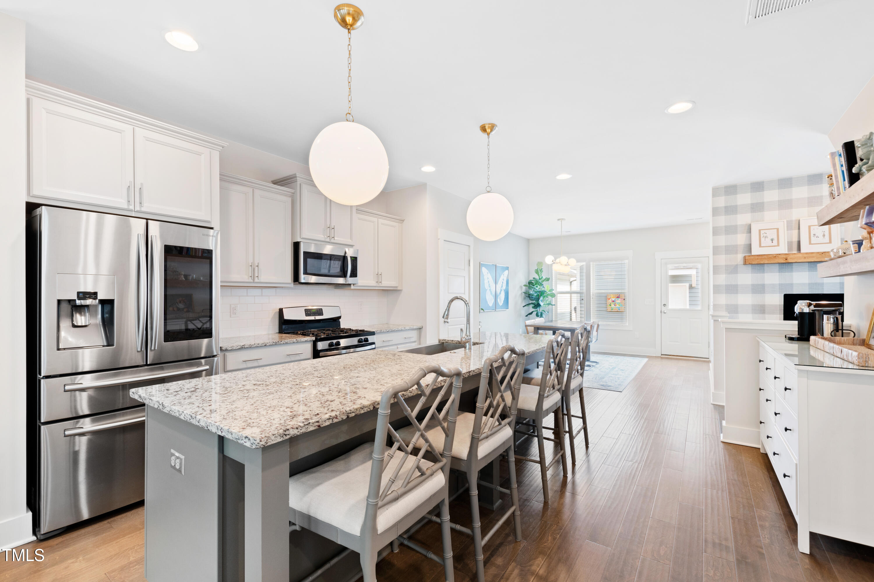 71 Hawk Point Road Chapel Hill, NC 27516 - Photo 14 of 35 a kitchen with stainless steel appliances granite countertop a stove top oven a refrigerator a sink and dishwasher with wooden floor