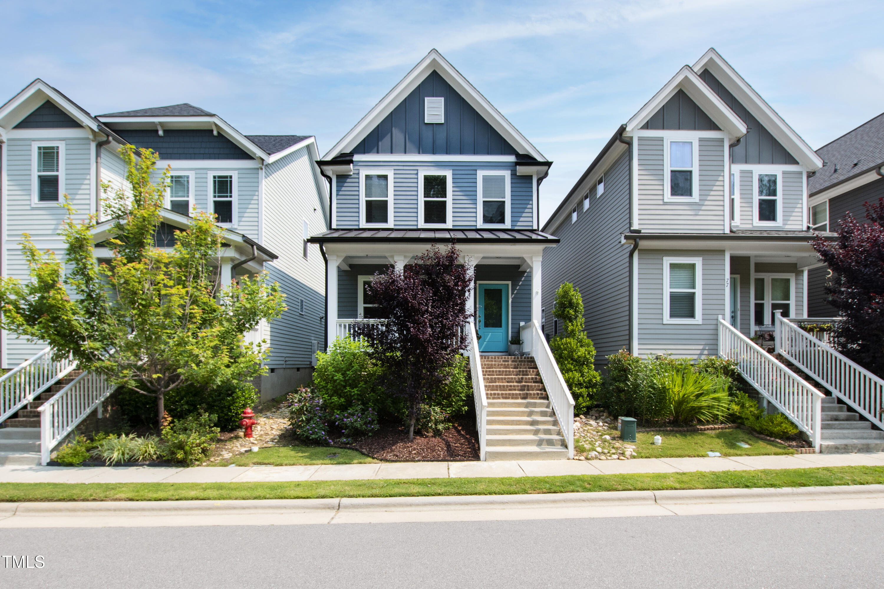 71 Hawk Point Road Chapel Hill, NC 27516 - Photo 2 of 35 a front view of a house with a yard and potted plants