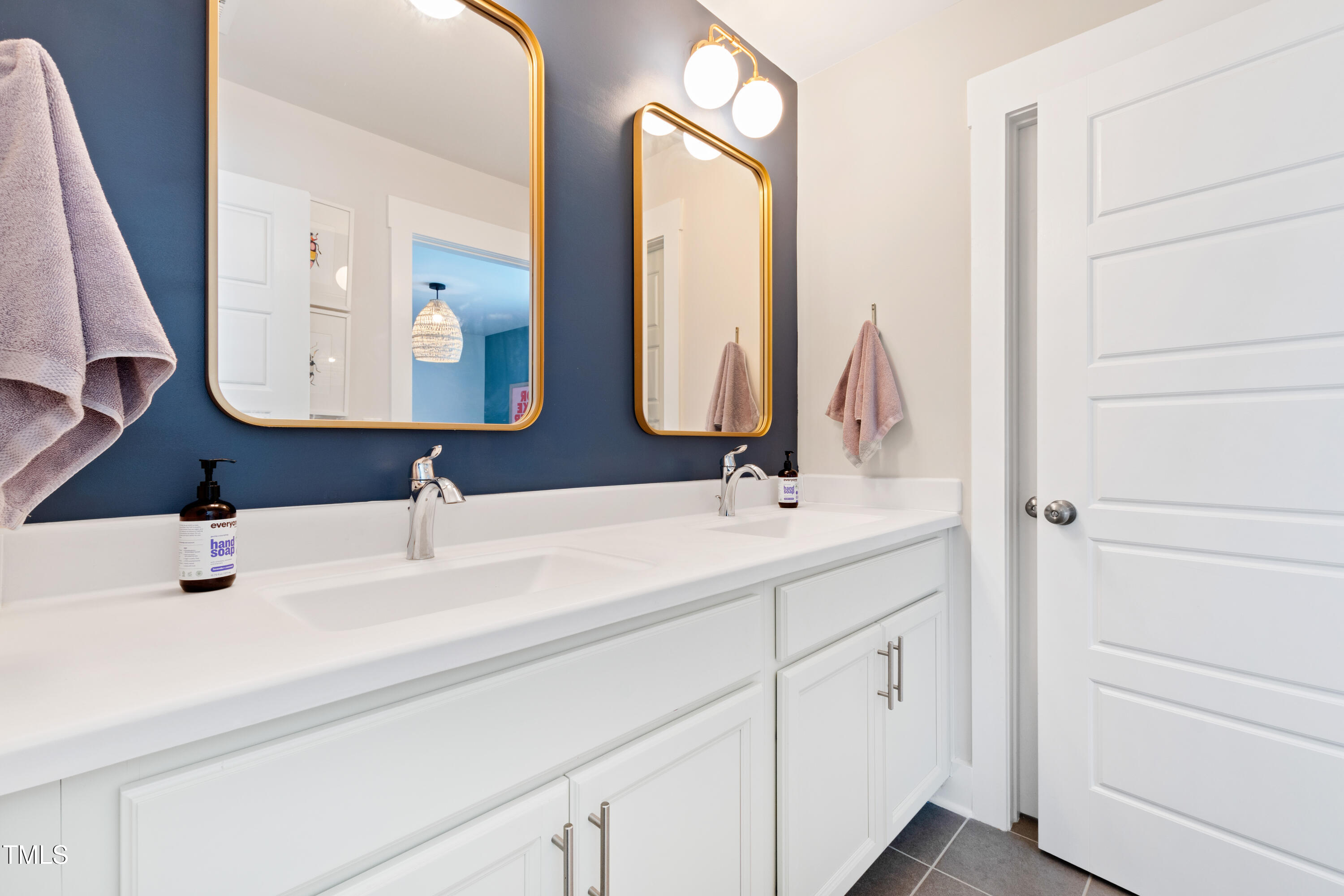 71 Hawk Point Road Chapel Hill, NC 27516 - Photo 31 of 35 a bathroom with a double vanity sink and mirror