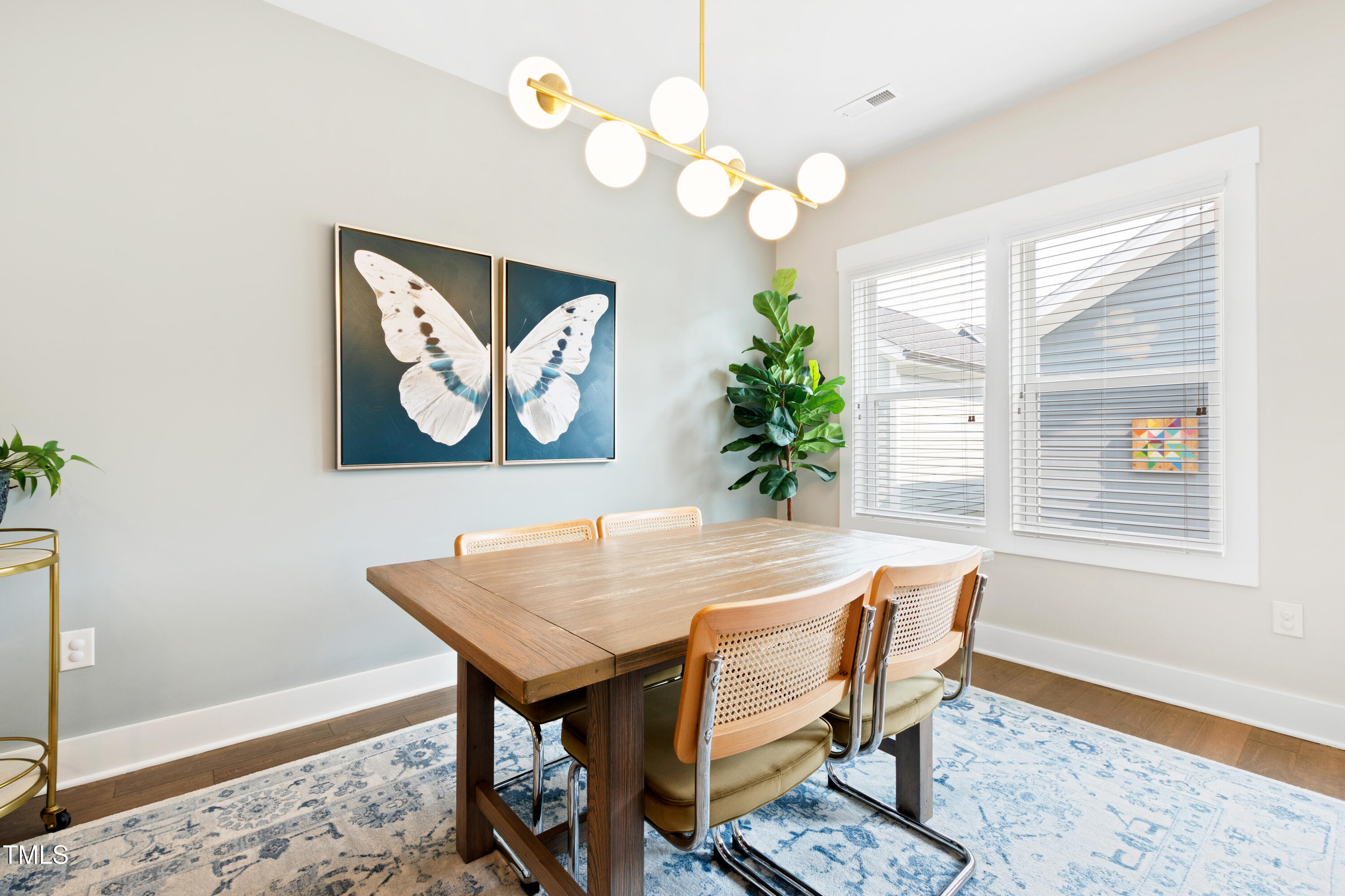 71 Hawk Point Road Chapel Hill, NC 27516 - Photo 6 of 35 a dining room with wooden floor and a chandelier