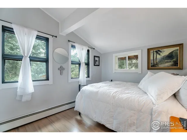 a bedroom with a large bed and a window