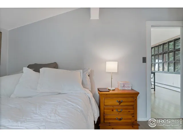 a bedroom with a bed and a night stand