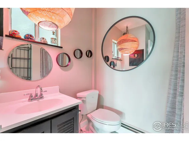 a bathroom with a toilet a sink and a mirror