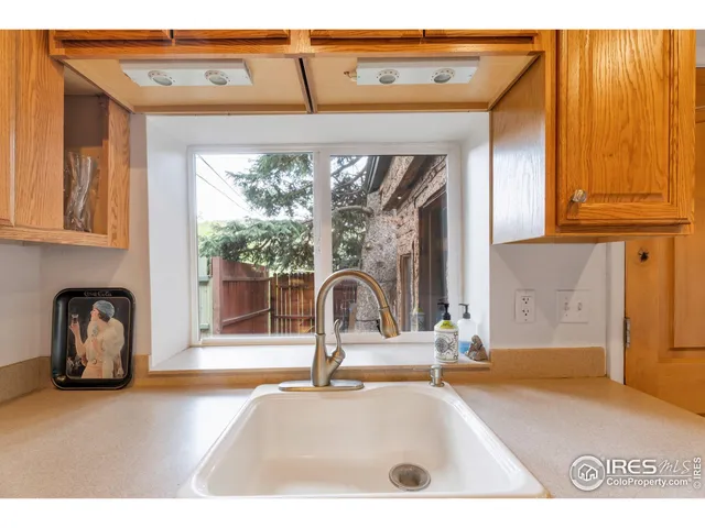 a picture of a living room with a sink and mirror