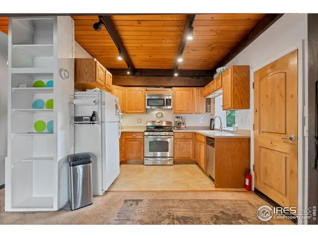a kitchen with stainless steel appliances granite countertop a refrigerator and a stove