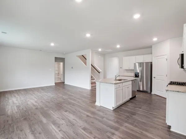a kitchen with furniture and a wooden floor