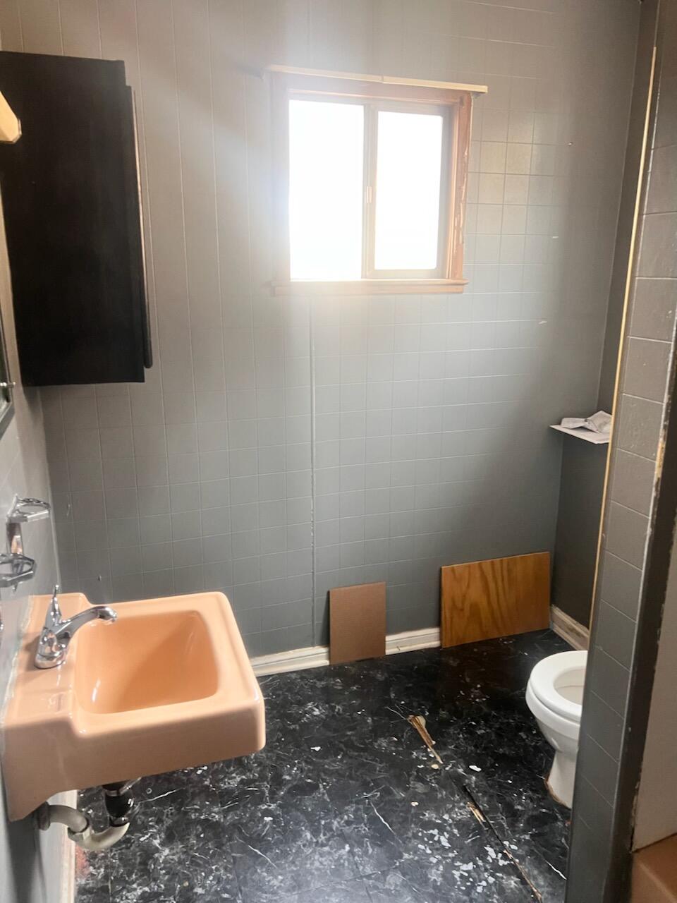 1618 Read Mountain Road Northeast Roanoke, VA 24019 - Photo 7 of 11 a bathroom with a sink a toilet a mirror and a window