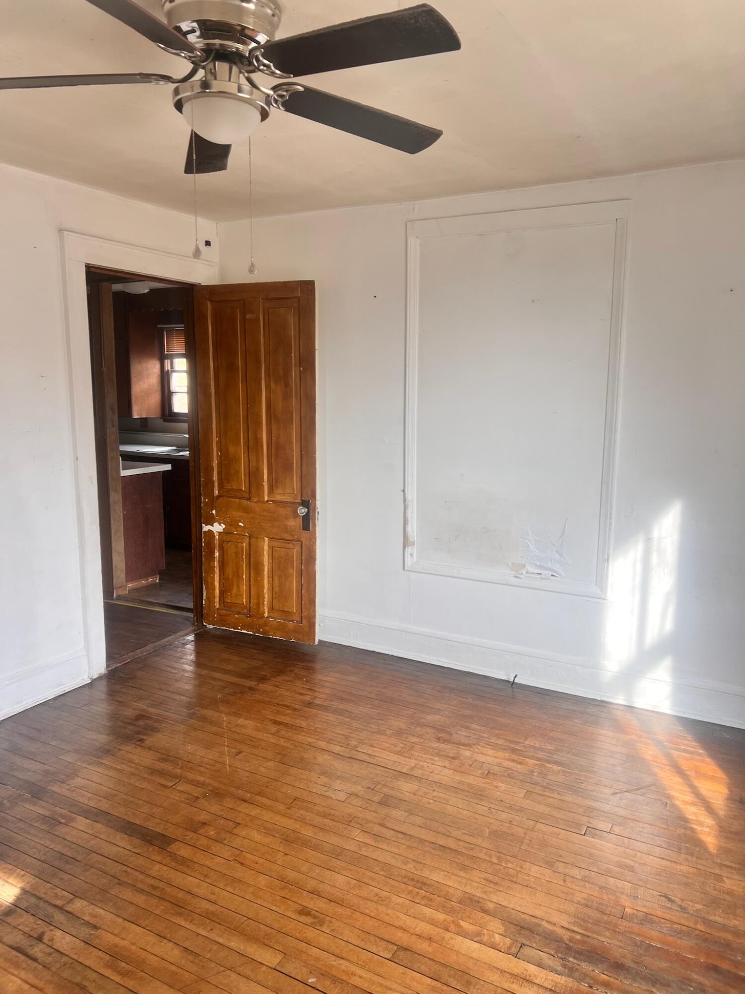 1618 Read Mountain Road Northeast Roanoke, VA 24019 - Photo 9 of 11 a view of an empty room with window and wooden floor