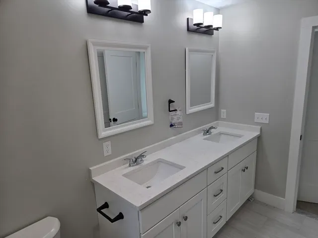 a bathroom with a sink vanity and mirror