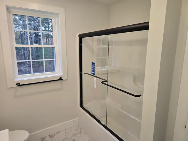 a bathroom with a glass shower door