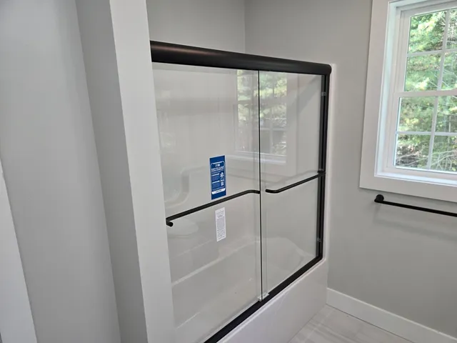 a bathroom with a glass shower door