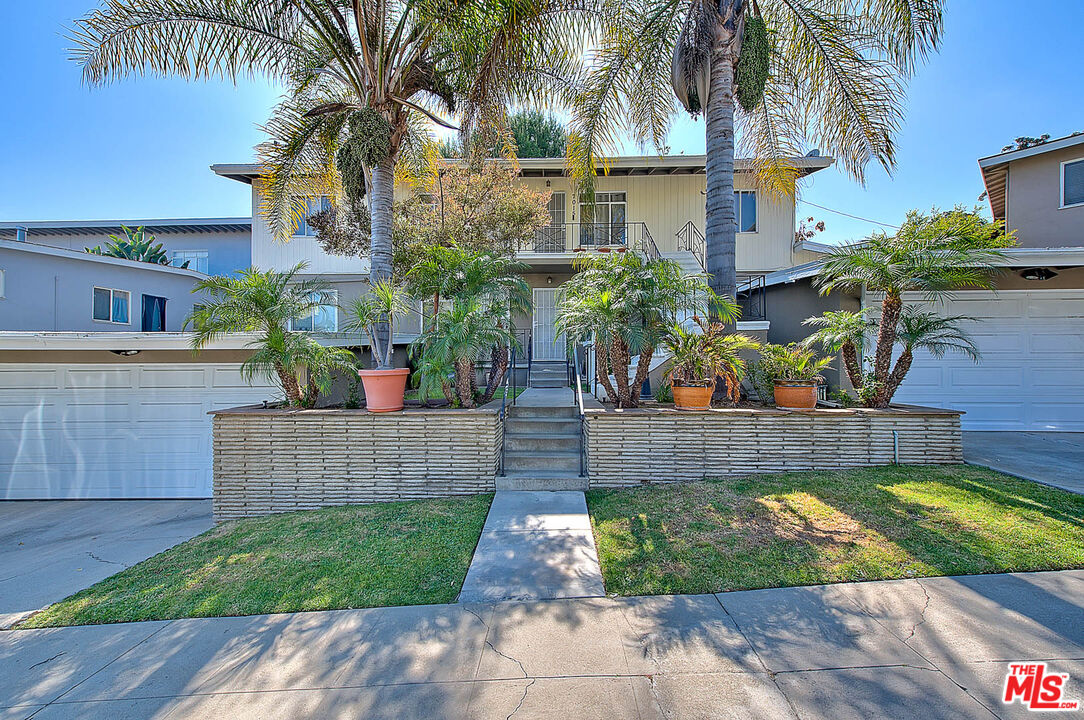 7017 Ramsgate Place Los Angeles, CA 90045 - Photo 1 of 32 a front view of a house with a garden