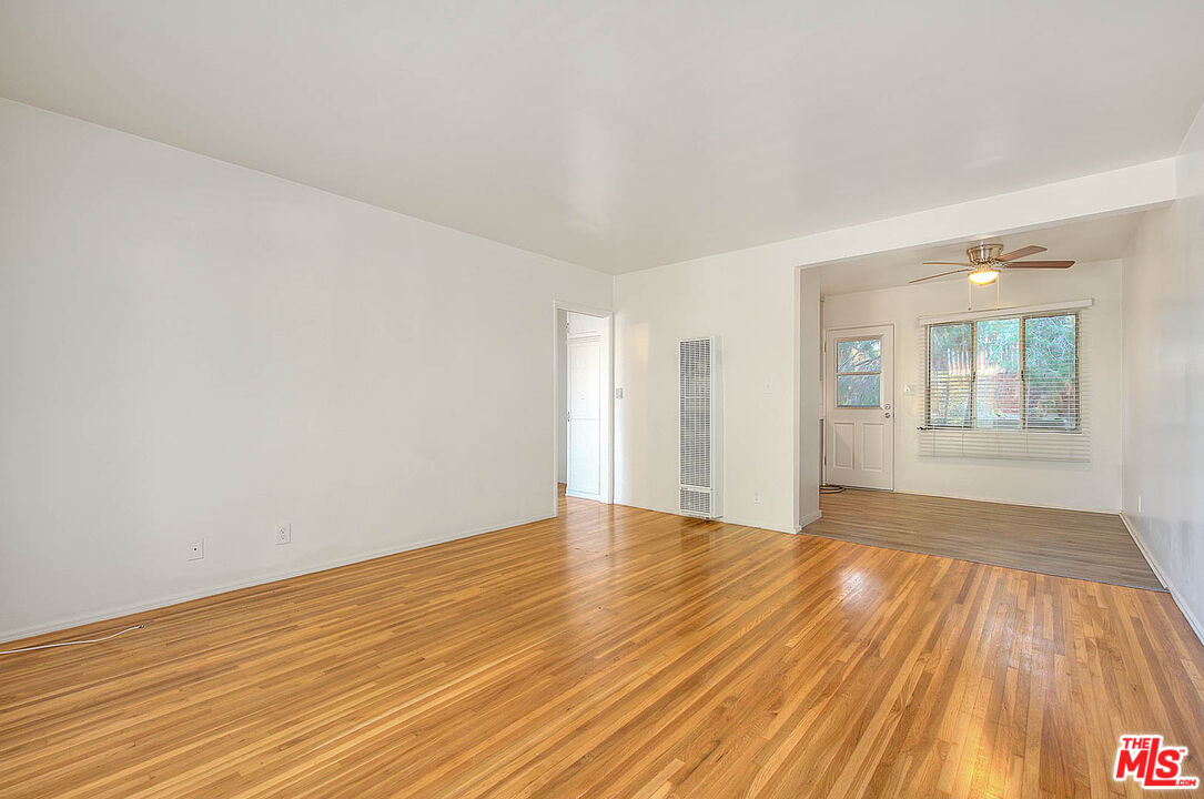 7017 Ramsgate Place Los Angeles, CA 90045 - Photo 11 of 32 an empty room with wooden floor and windows