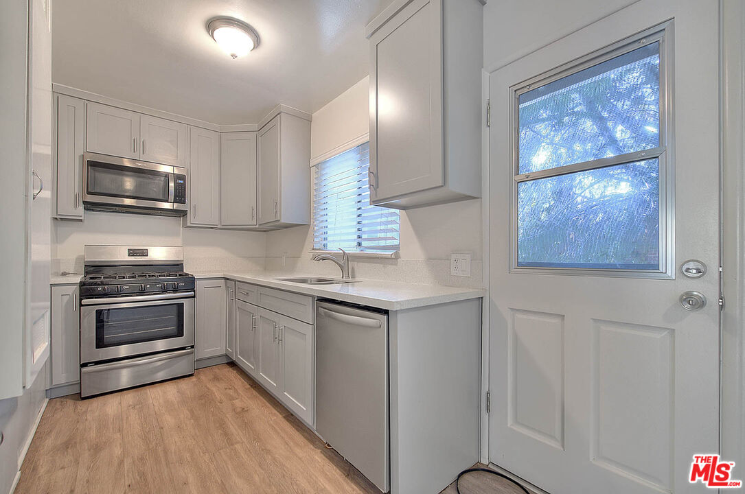 7017 Ramsgate Place Los Angeles, CA 90045 - Photo 14 of 32 a kitchen with stainless steel appliances a stove microwave and sink