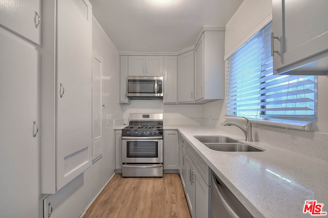 7017 Ramsgate Place Los Angeles, CA 90045 - Photo 15 of 32 a kitchen with a sink appliances and cabinets