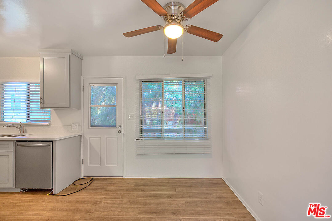 7017 Ramsgate Place Los Angeles, CA 90045 - Photo 18 of 32 a view of a kitchen with wooden floor and a ceiling fan