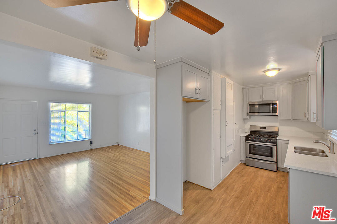 7017 Ramsgate Place Los Angeles, CA 90045 - Photo 20 of 32 a view of a kitchen with a sink stove refrigerator and cabinets