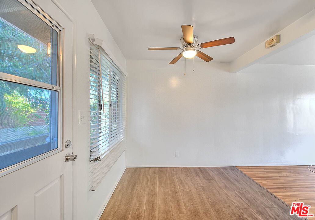 7017 Ramsgate Place Los Angeles, CA 90045 - Photo 21 of 32 a view of empty room with wooden floor and fan