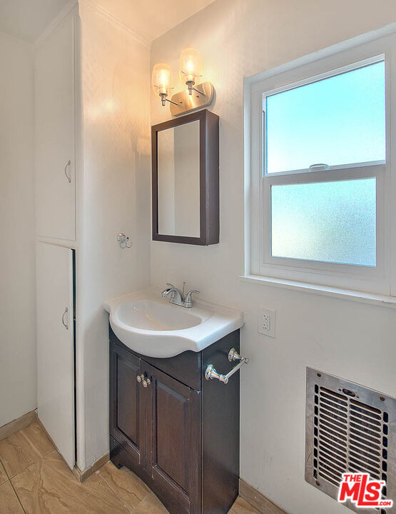 7017 Ramsgate Place Los Angeles, CA 90045 - Photo 26 of 32 a bathroom with a sink a vanity and a mirror