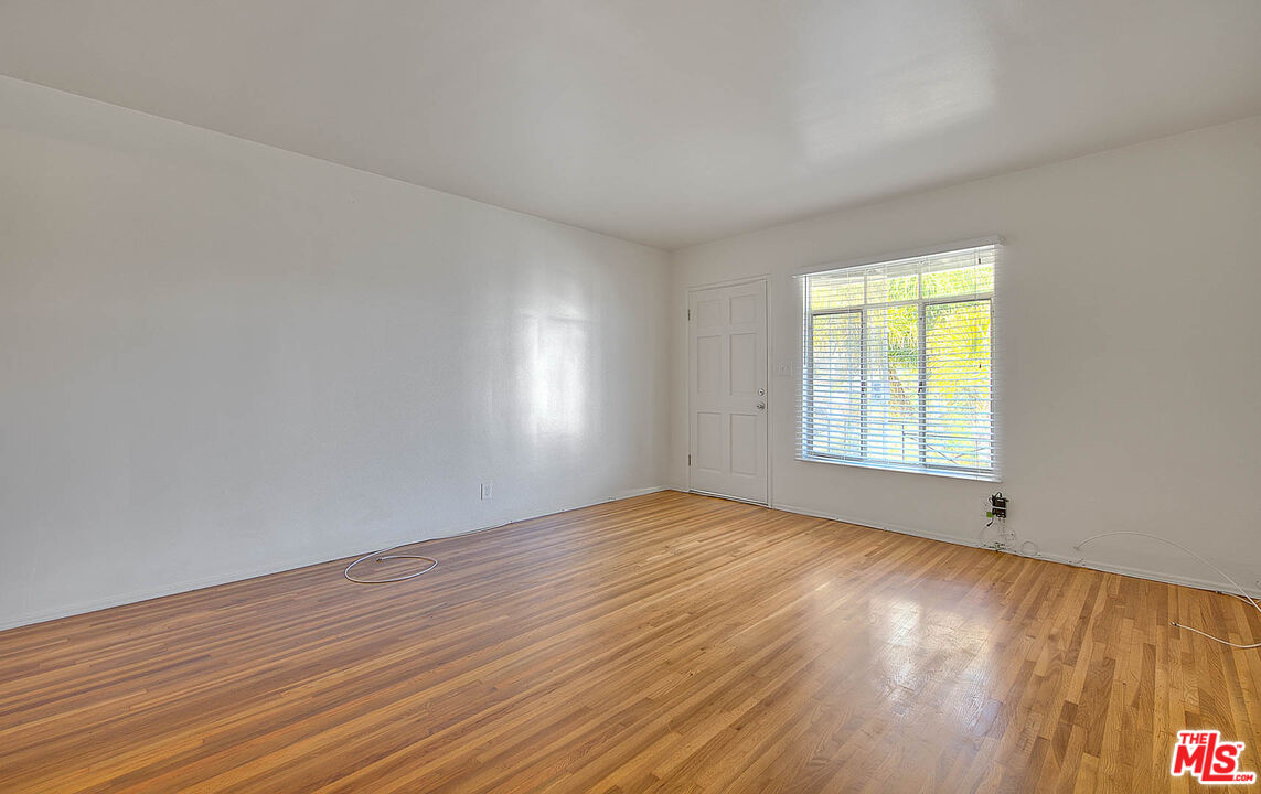 7017 Ramsgate Place Los Angeles, CA 90045 - Photo 8 of 32 an empty room with wooden floor and windows