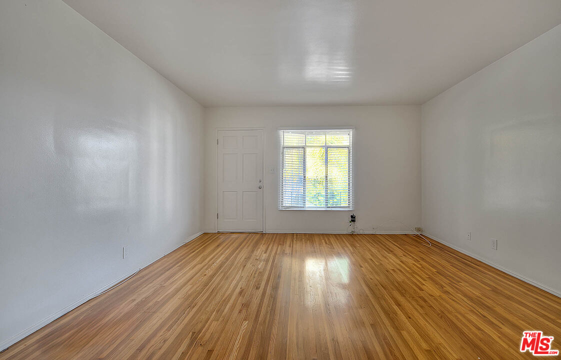 7017 Ramsgate Place Los Angeles, CA 90045 - Photo 9 of 32 an empty room with wooden floor and windows