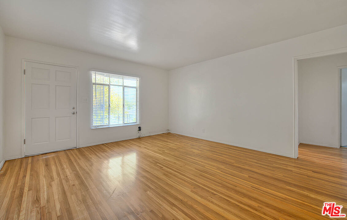 7017 Ramsgate Place Los Angeles, CA 90045 - Photo 10 of 32 an empty room with wooden floor and windows